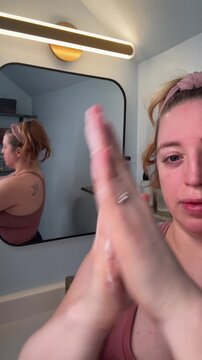 skincare routine of a woman scrubbing face with a powdered cleanser