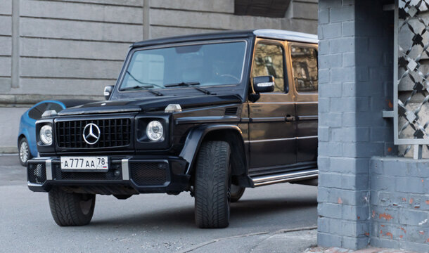 Black Mercedes Benz G63 AMG parked in the city street. Black Mercedes-Benz W500 G-class in the center of the town. Gel&auml;ndewagen. Brabus G Wagon.
