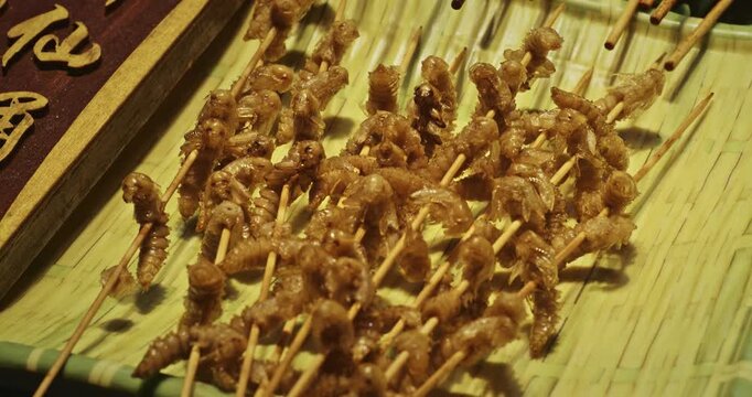 Chengdu, Sichuan, China. Pupa Or Larvae Fried Food On Skewers. Fried Insect Larvae Snack As Exotic Food In China. Fried Larvae Popular Snacks In Southeast Asia And New Source Of Protein. Bizarre Food