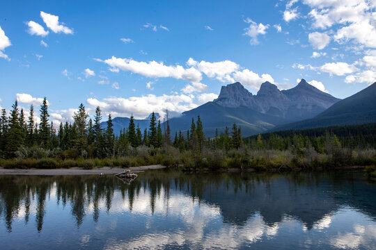 Majestic Mountain Range Reflected in Calm Alpine Lake With Fores