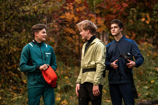 Young male friends chat during a workout in the park.