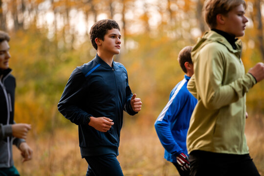 Group of boys running during autumn. active healthy lifestyle concept.