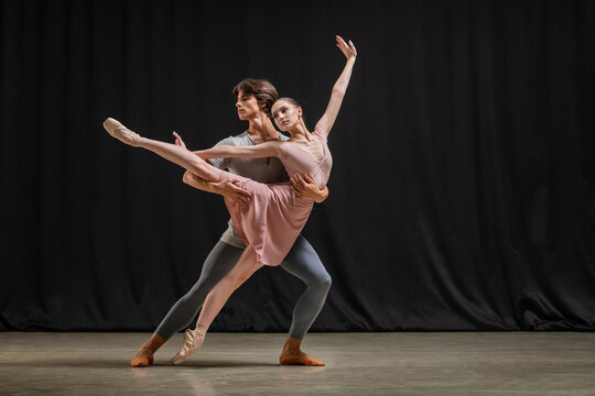 Professional ballet duo practicing contemporary dance on stage. .