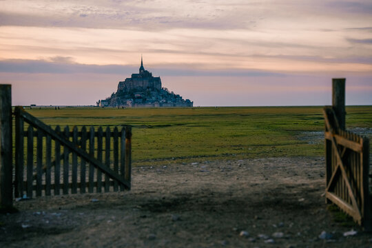 View of Mont Saint-Michel during sunset from an open gate in Normandy