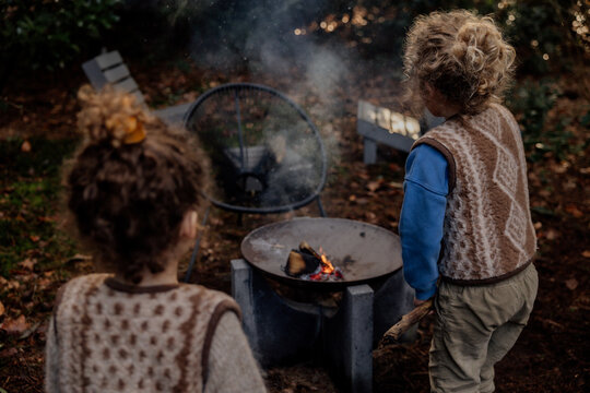 Children creating a bonfire on camping ground