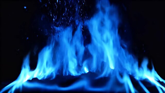 A striking image showcases vibrant blue flames dancing against a stark black background, creating a mesmerizing display of heat and light.