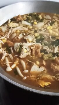 a cuisine photo of budae jjigae soup. close up view of delicious asian food