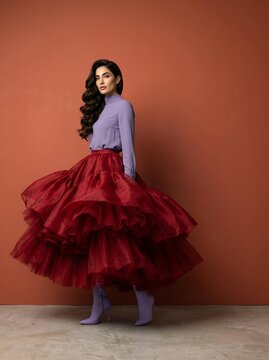 Beautiful woman in lavender shirt and massive red tulle skirt
