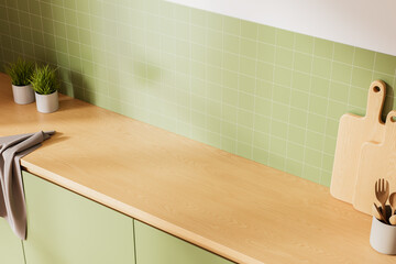 Obraz na płótnie Canvas Minimalist kitchen interior with wooden countertop, green tiled backsplash, utensils and plants arranged for product mockup display in bright presentation style. 3D Rendering