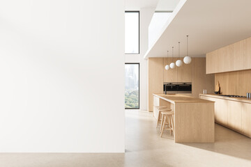 Minimalist modern kitchen interior with light wood cabinetry, long island, stools, pendant lights,...