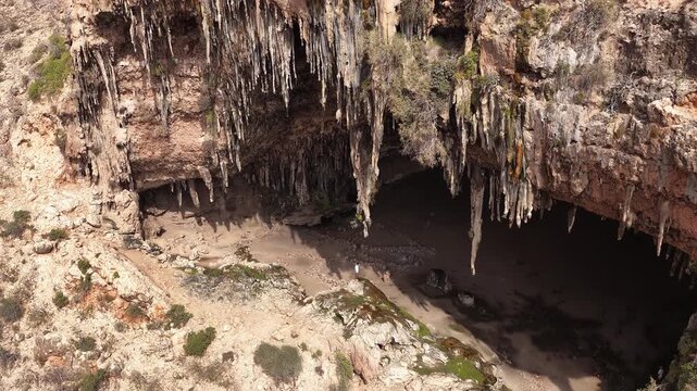 Aerial view of a large cave with stalactites hanging from the ceiling in Socotra, yemen