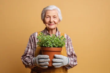 senior woman holding plant © bmf-foto.de