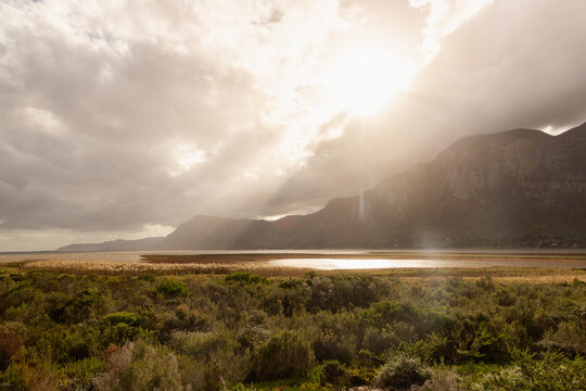sunlight over fields, lagoon and Klein Mountain, Stanford, South Africa