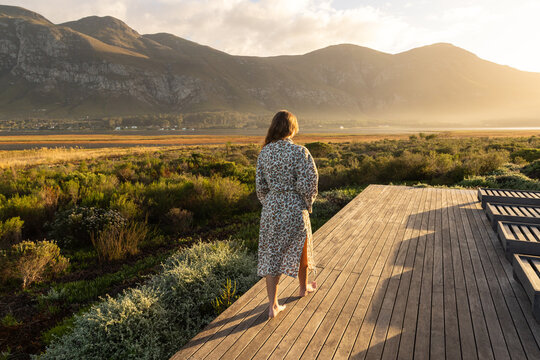 rear view of young woman at sunrise ,View towards Lagoon and Klein Mountains, Stanford, South Africa