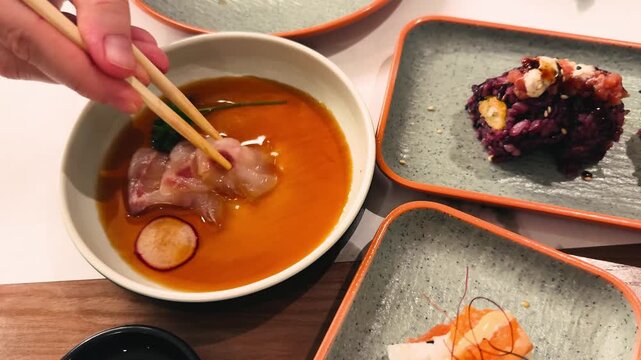 Shiromi, a Japanese delicacy made from thinly sliced raw halibut fillet, is a delicately flavored dish served chilled with soy sauce.