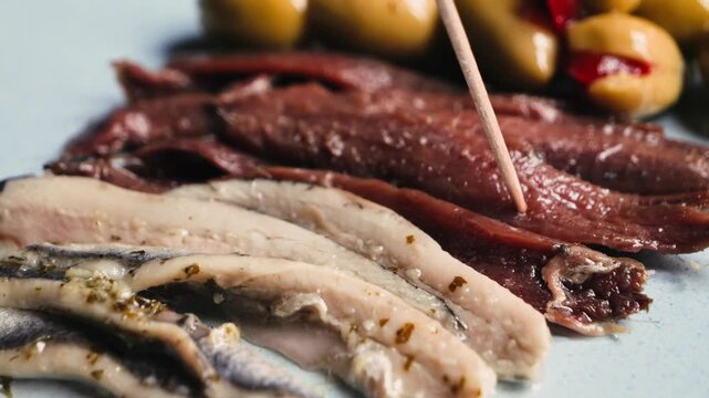 Traditional Catalan snacks for wine, beer and vermouth include green olives and anchovies.