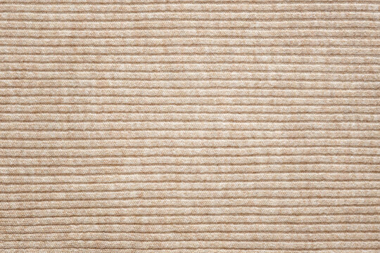 Light beige knitted background with horizontal lines