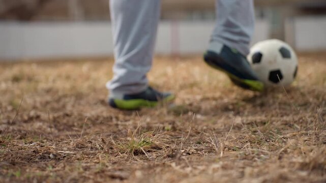 soccer foot contact, closeup of kicking action, foot striking ball during game, intimate view of foot making contact with ball, detailed shot capturing foot control and ball impact on grass field