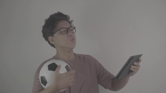 Southeast Asians watch football on their tablets, feeling frustrated and annoyed when their team comes close to scoring. S-Log3, S-Gamut3.Cine