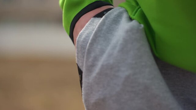 pants pocket grab, closeup of pocket opening outdoors, fingers reaching mobile phone from sweatpants pocket, closeup of hands retrieving mobile device from sweatpants pocket while outdoors