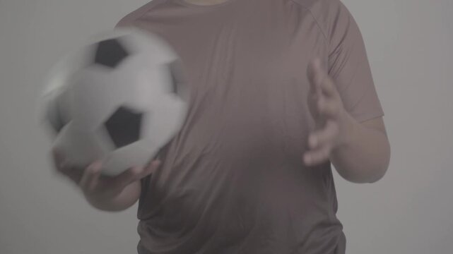 close up shot of a person wearing a brown jersey, moving a soccer ball to the right and left  S-Log3, S-Gamut3.Cine