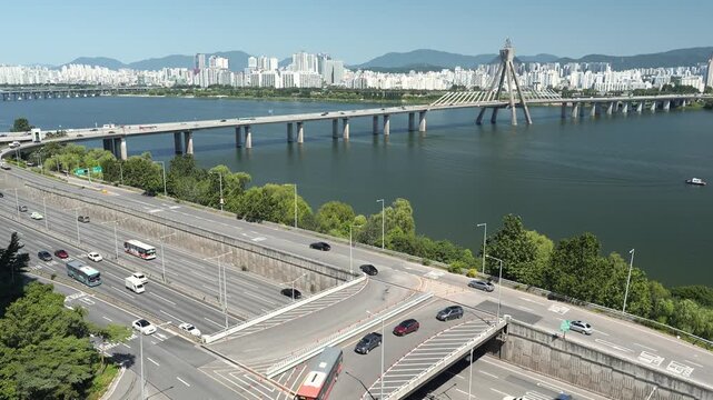 Seoul, South Korea - Jul. 11, 2026 : Aerial view of Olympic Bridge and Gangbyeonbuk-ro highway traffic in Seoul.