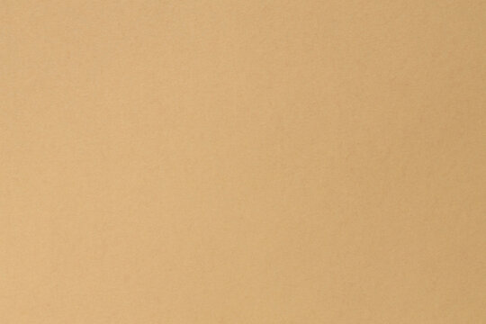Smooth beige cardboard paper texture background with natural fiber pattern for design