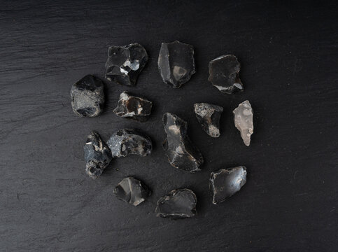 Natural black flint, chert mineral on slate plate