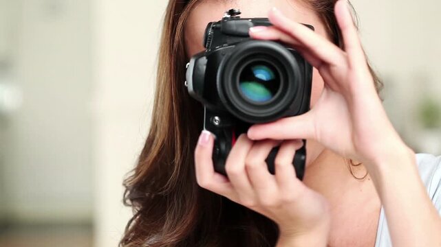 Woman, face and photographer with camera for angle, instruction or capture with lens in home studio. Portrait, female person or photoshoot with frame or smile for photography or direction in house