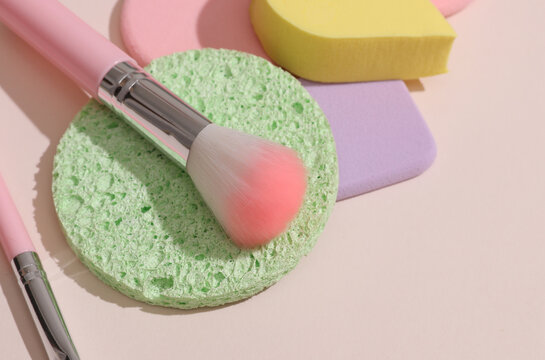 Set of cosmetic products for makeup on a beige background with shadow. Beauty concept. Flat lay