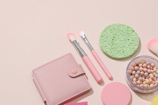 Set of cosmetic products for makeup on a beige background with shadow. Beauty concept. Flat lay