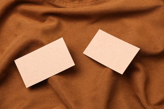 Craft business cards on tobacco colored suede background