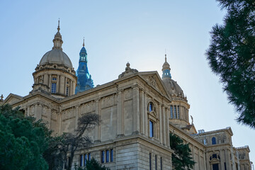 Fototapeta premium Museu Nacional d'Art de Catalunya,Barcelona,Spain,Grand historical building with domes and classical architecture under a clear sky