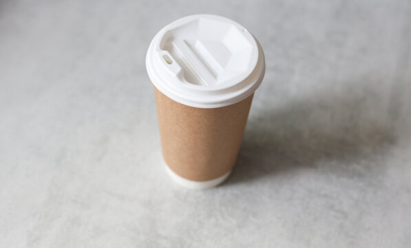 Craft cardboard coffee cup on a concrete countertop