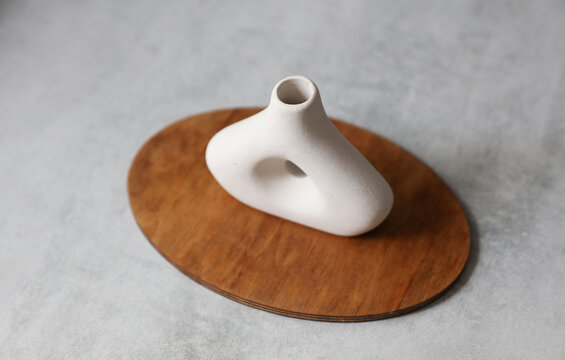Minimalist plaster vase on concrete countertop