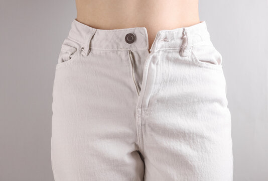 Slim sexy woman figure dressed in white denim jeans