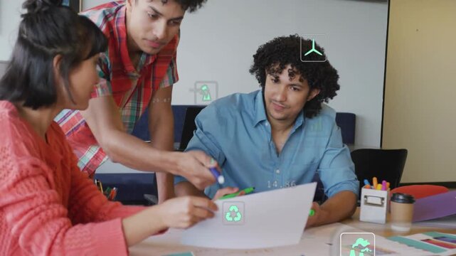 Working team leaning over meeting, coral-sweater marking sheet with green pen amid AR-overlays