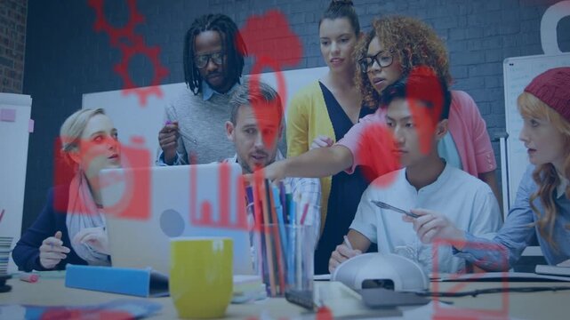 Design team gathering around laptop, pointing and operating, making red icons highlighting designs