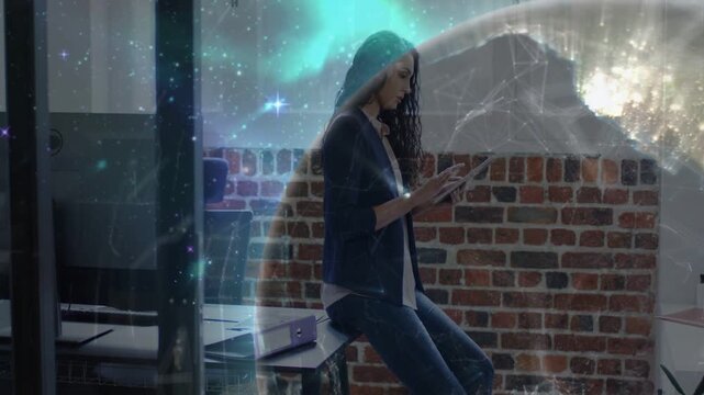 Woman tapping tablet in tech office, globe overlay growing around her, showcasing global data
