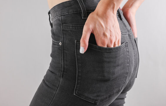 Slim sexy woman figure dressed in dark gray jeans