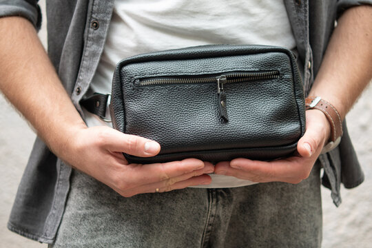 Man with a black leather belt bag