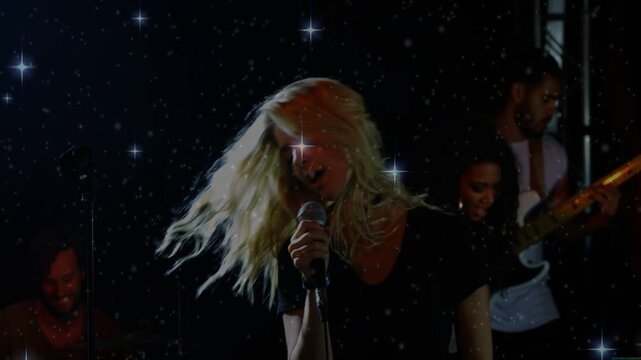 Intro chord starting, lead singer singing and hair whipping with band backing, emphasizing finale