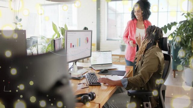 Lead walking to seated analyst showing tablet and causing live chart updates for business review