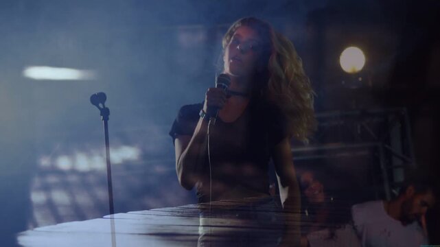 Music starting singer whipping head bringing mic to chest singing wood plank under singer rising