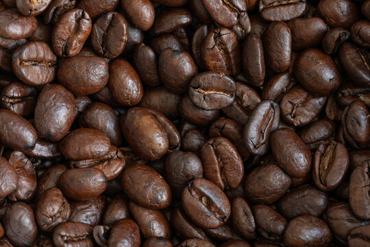 Macro view of roasted highland Arabica coffee beans (Coffea arabica). Dark brown texture. Alajuela, Alajuela, Costa Rica.