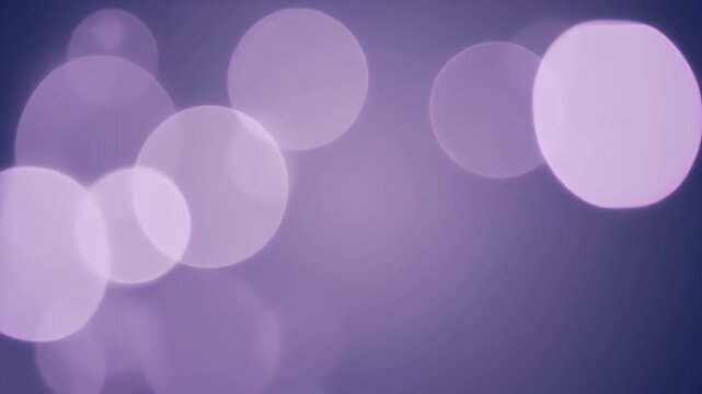 Vibrant purple bokeh lights shine brightly in a dark room atmosphere.