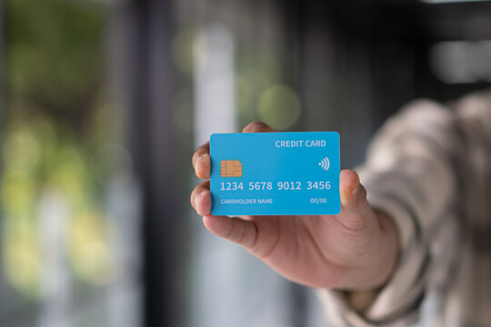 Close up Hand showing blue credit card. Digital Banking. Cashless. Payment method. technology.