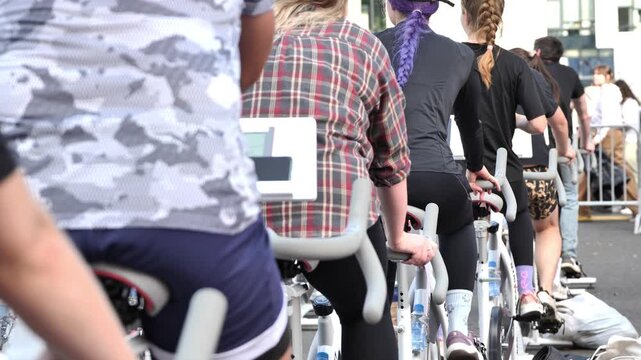 People engaging in an outdoor spin cycle workout for fitness and well-being
