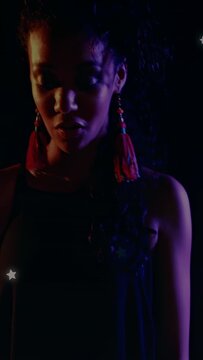 Vertical video: Singer starting hands on keys, performing as cam pulling back, stars lighting music