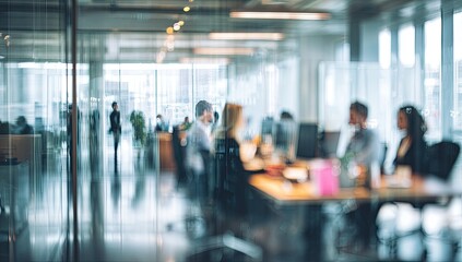 Fototapeta premium Abstract, out-of-focus view of a busy corporate office environment with workers